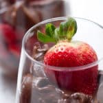 close up of chocolate pudding garnished with a strawberry
