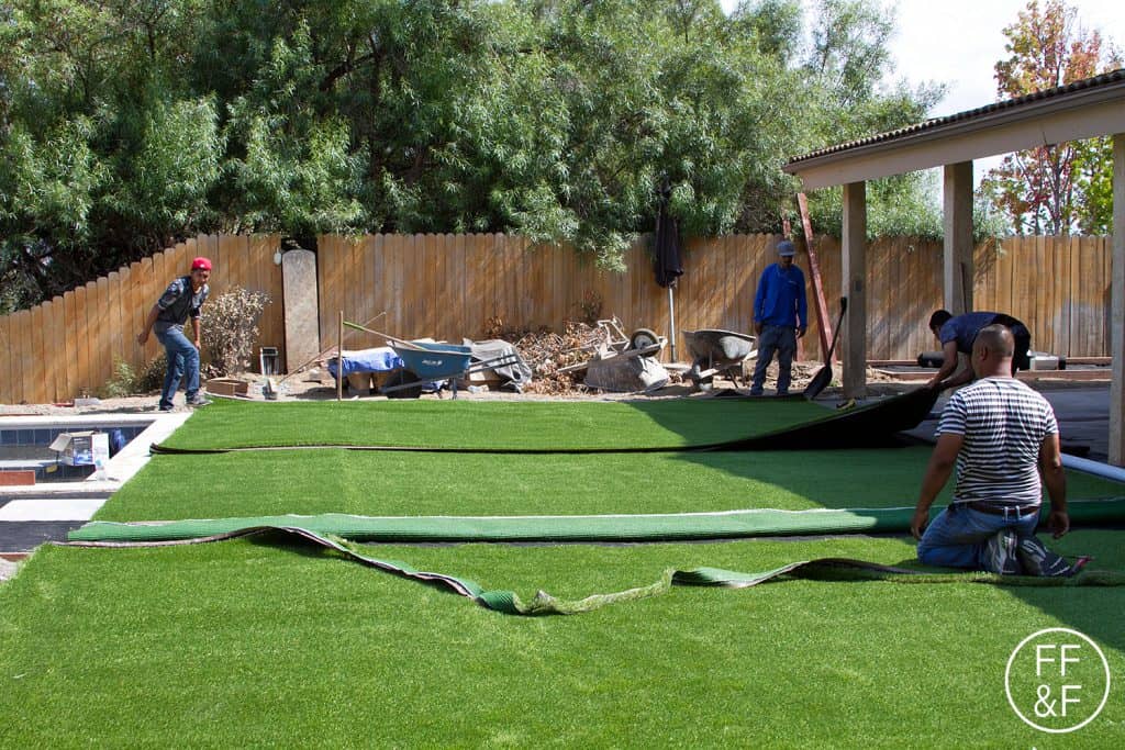 Placing artificial turf in our backyard during the renovation. #bethhomeproject