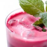 close up of beet juice garnished with mint sprig