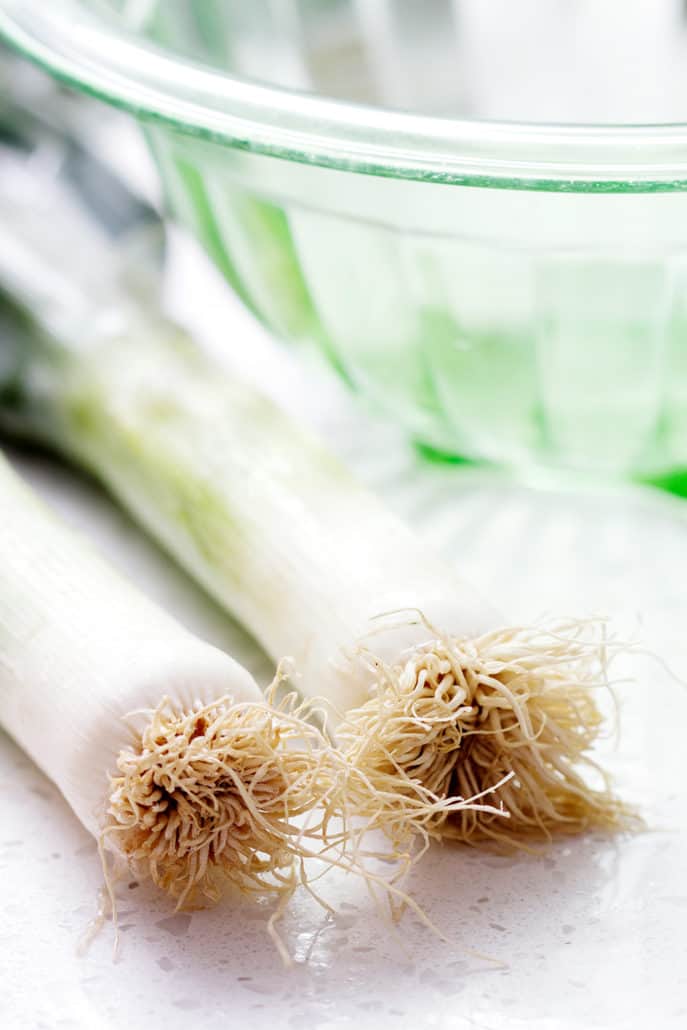 close up of leeks and glass bowl