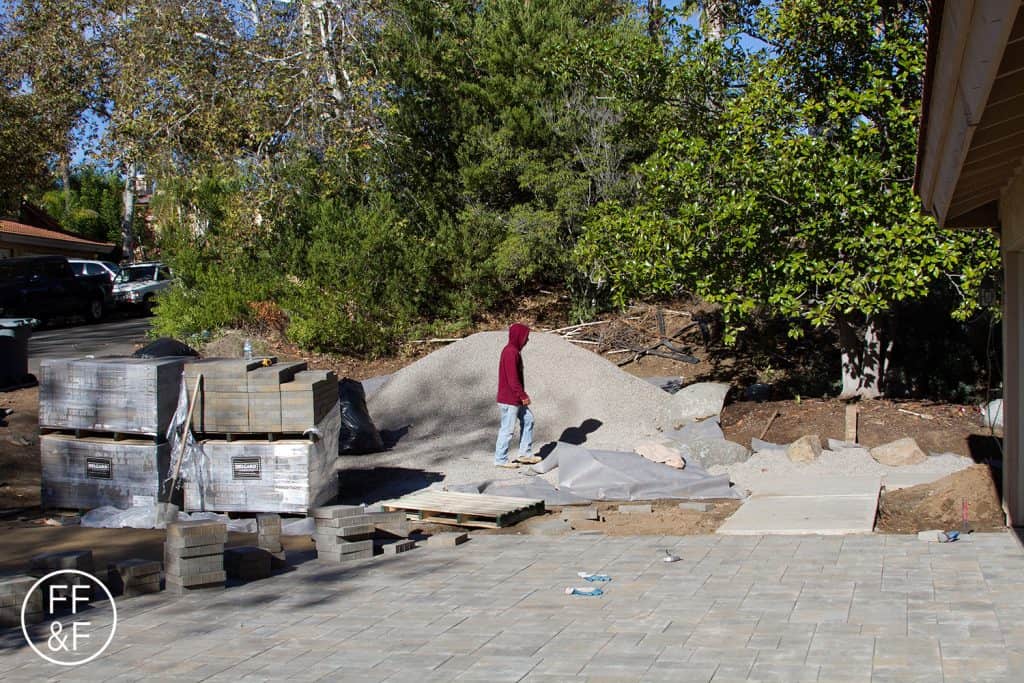 Installing pavers for the driveway during front yard renovation.