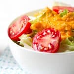 carrot ginger salad dressing on bowl of salad