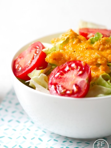 carrot ginger salad dressing on bowl of salad