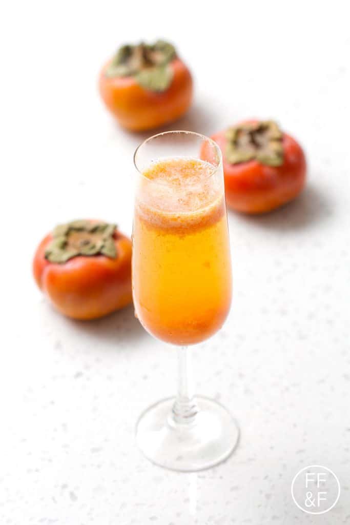 Spiced Persimmon Sparkler is a cinnamony champagne cocktail with a fruity persimmon puree.