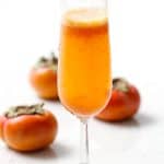 Spiced Persimmon Sparkler is a cinnamony champagne cocktail with a fruity persimmon puree.