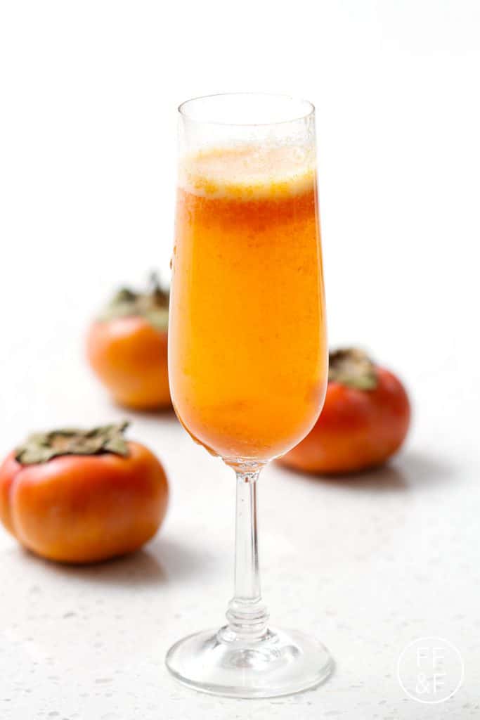 Spiced Persimmon Sparkler is a cinnamony champagne cocktail with a fruity persimmon puree.