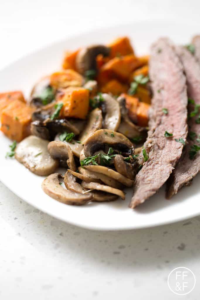 This Sheet Pan Steak Dinner is quick and easy with very little cleanup. This flank steak with mushrooms and sweet potatoes dish is one that your family will request again and again!