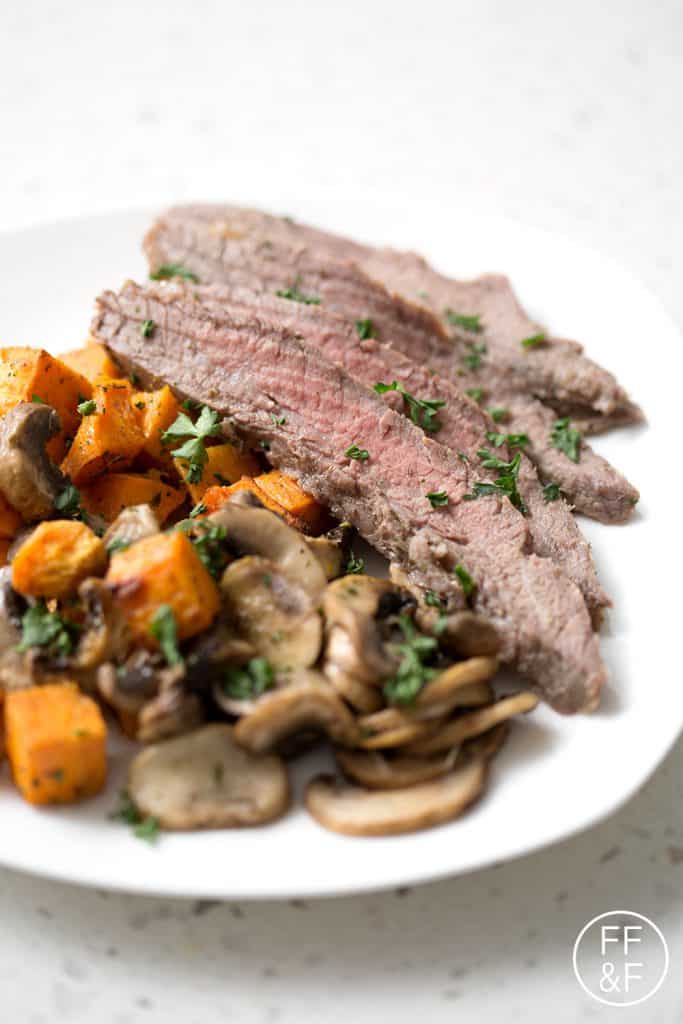 This Sheet Pan Steak Dinner is quick and easy with very little cleanup. This flank steak with mushrooms and sweet potatoes dish is one that your family will request again and again!