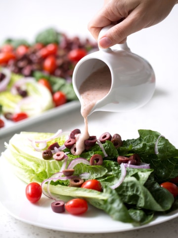 A simple recipe for an autoimmune protocol approved Mediterranean Salad. Romaine lettuce is the base for lots of onions, tomatoes, kalamata olives and homemade Mediterranean Salad Dressing. This recipe is allergy friendly (gluten, dairy, shellfish, nut, egg, and soy free) and suits the autoimmune protocol (AIP) and paleo diets.