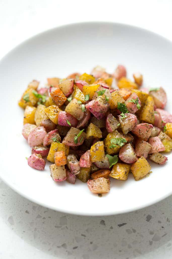 This recipe for Roasted Root Vegetables uses radishes, sweet potatoes and beets with just a few other ingredients to make a colorful and hearty veggie side dish. It’s time to make this dish an AIP veggie go-to for healthy, delicious and easy meals. This recipe is allergy friendly (gluten, dairy, shellfish, nut, egg, and soy free) and suits the autoimmune protocol (AIP) and paleo diets.
