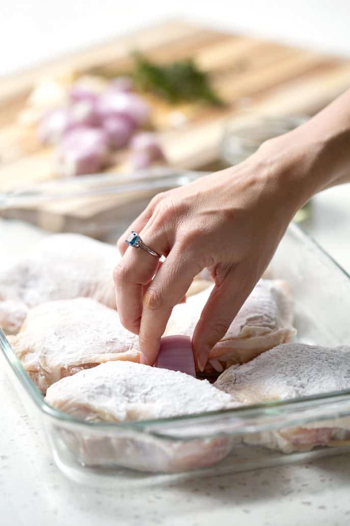 placing chicken in roasting pan