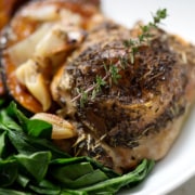 roast chicken with greens and sprig of thyme