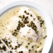 fish fillets on serving platter with capers and sauce