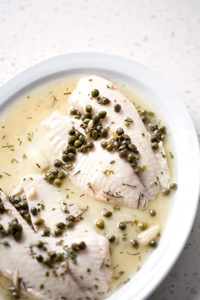 fish fillets on serving platter with capers and sauce