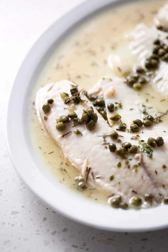 fish fillets with capers on serving plate