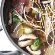 mushrooms, bok choy and meat in bone broth