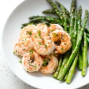 seasoned shrimp with asparagus on white background