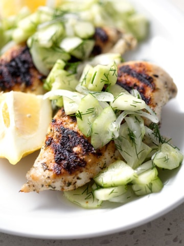 Grilled Chicken and Cucumber Dill Salad on white background