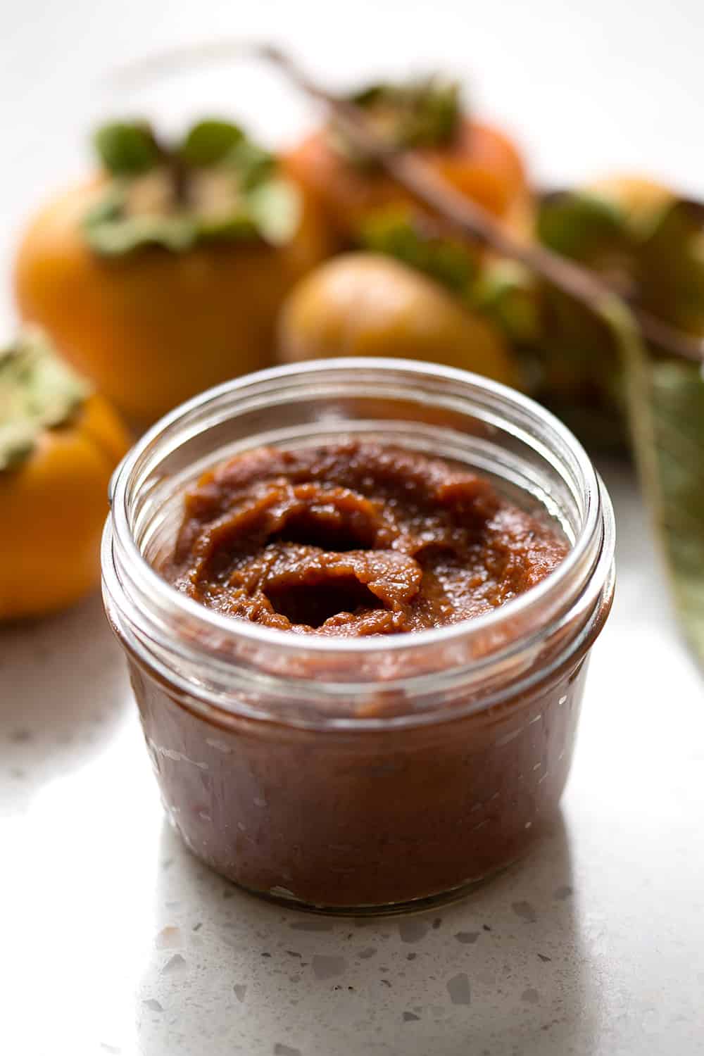 Persimmon season is a short one but I encourage you to scoop them up and make this Spiced Persimmon Butter. It’s similar to pumpkin or apple butter but made with persimmons and some extra spices for those yummy fall and winter flavors. This recipe is allergy friendly (gluten, dairy, shellfish, nut, egg, and soy free) and suits the paleo diets