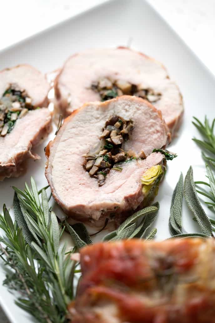 This Prosciutto Wrapped Pork Roast with Brussel Sprouts recipe is pork roast stuffed with savory mushrooms, onions and herbs then wrapped in salty prosciutto and fished off with brussel sprouts. It’s a complete meal in one dish. This recipe is allergy friendly (gluten, dairy, shellfish, nut, egg, and soy free) and suits the AIP and Paleo diets.