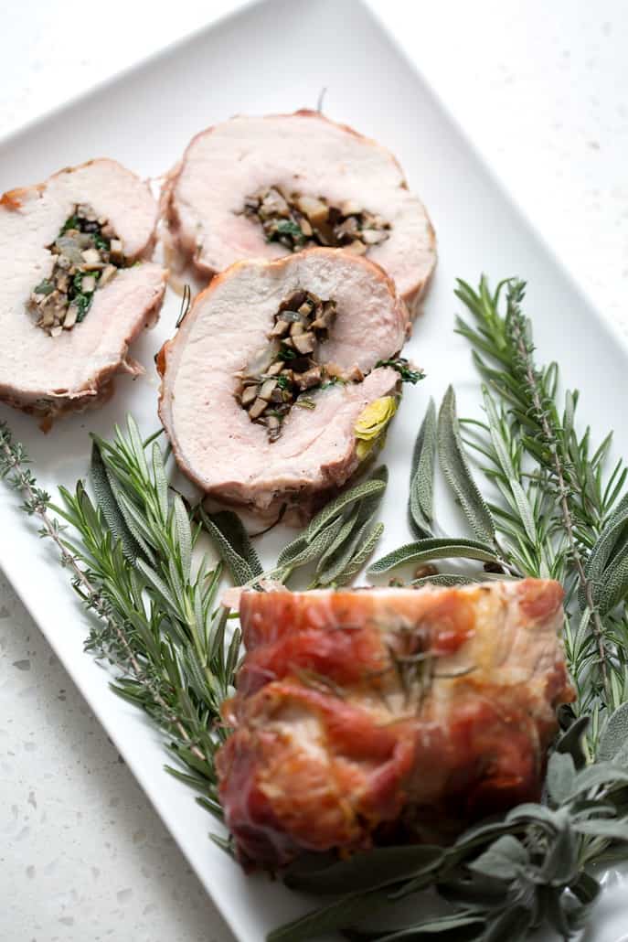 This Prosciutto Wrapped Pork Roast with Brussel Sprouts recipe is pork roast stuffed with savory mushrooms, onions and herbs then wrapped in salty prosciutto and fished off with brussel sprouts. It’s a complete meal in one dish. This recipe is allergy friendly (gluten, dairy, shellfish, nut, egg, and soy free) and suits the AIP and Paleo diets.