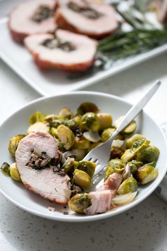 This Prosciutto Wrapped Pork Roast with Brussel Sprouts recipe is pork roast stuffed with savory mushrooms, onions and herbs then wrapped in salty prosciutto and fished off with brussel sprouts. It’s a complete meal in one dish. This recipe is allergy friendly (gluten, dairy, shellfish, nut, egg, and soy free) and suits the AIP and Paleo diets.