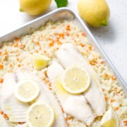 baking sheet with lemon, fish and cauliflower rice