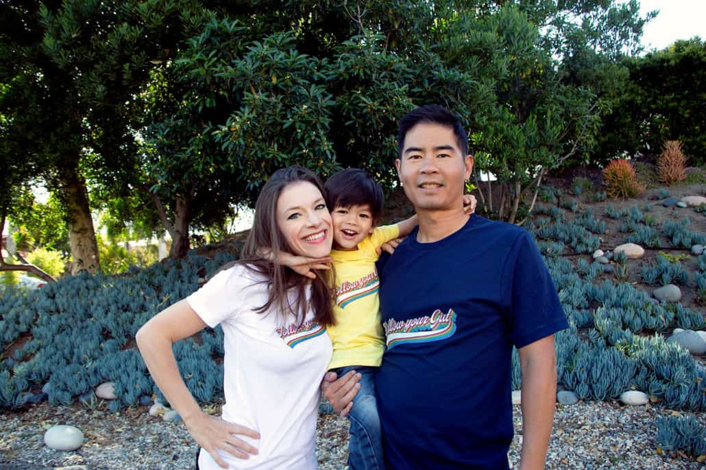 family hugging and wearing different color tshirts