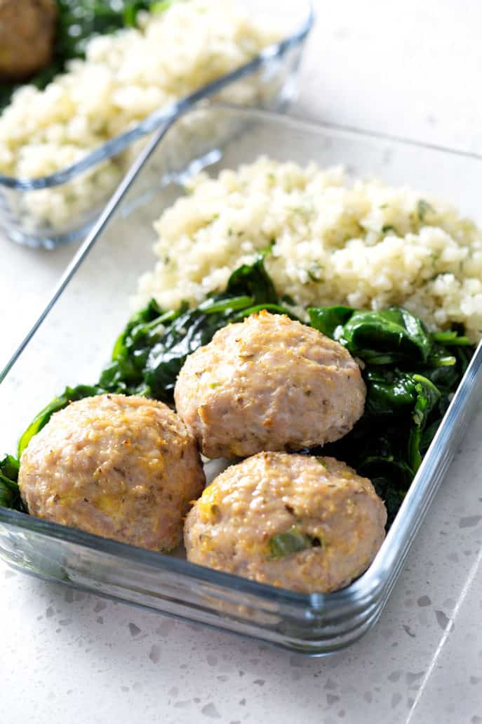 meatballs, spinach and rice in glass dish