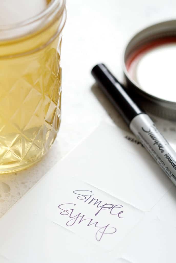 mason jar on counter with sharper and label that says simple syrup