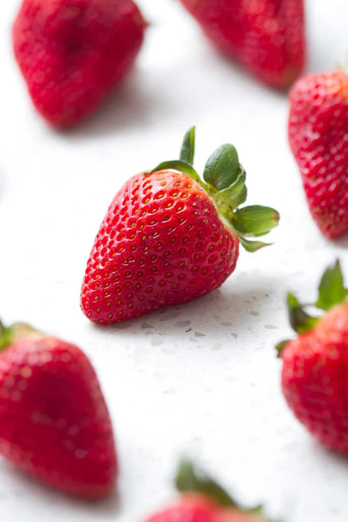 whole strawberries on white background
