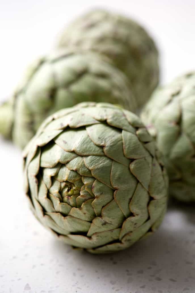 fresh artichokes on white background