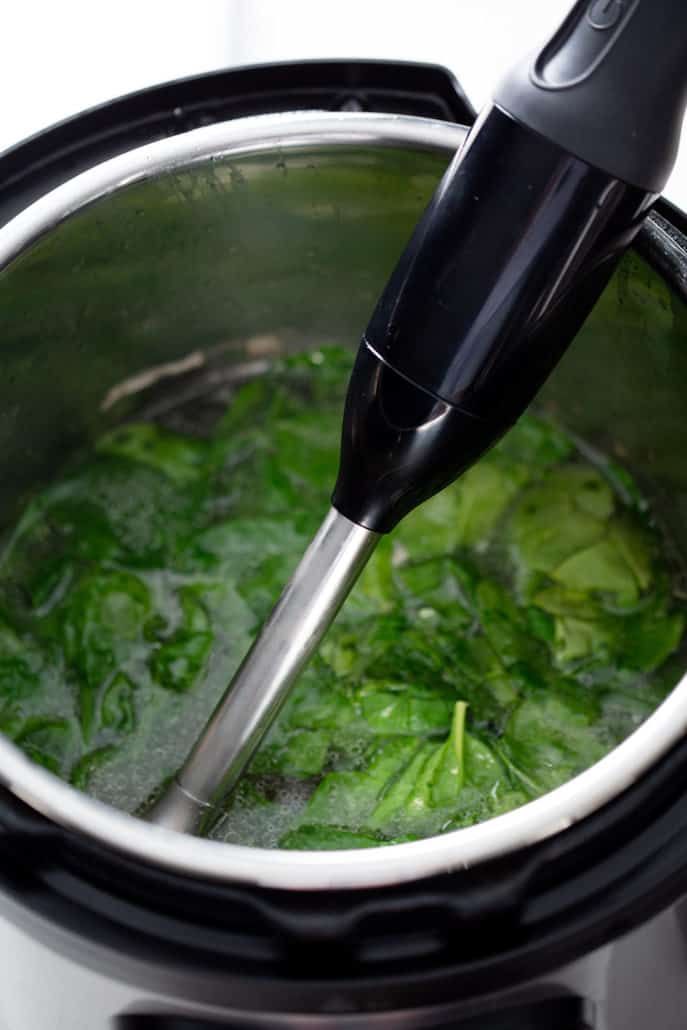 spinach in soup with immersion blender in instant pot