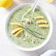 bowl of green soup with lemon and chive garnish from above