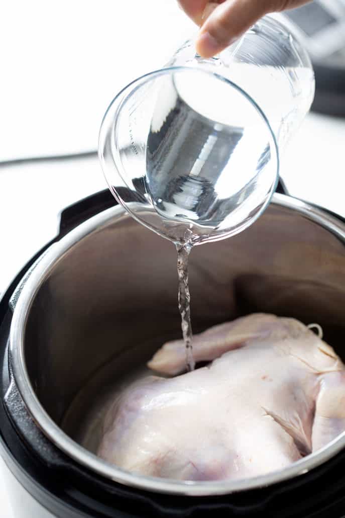 pouring water over whole chicken in instant pot