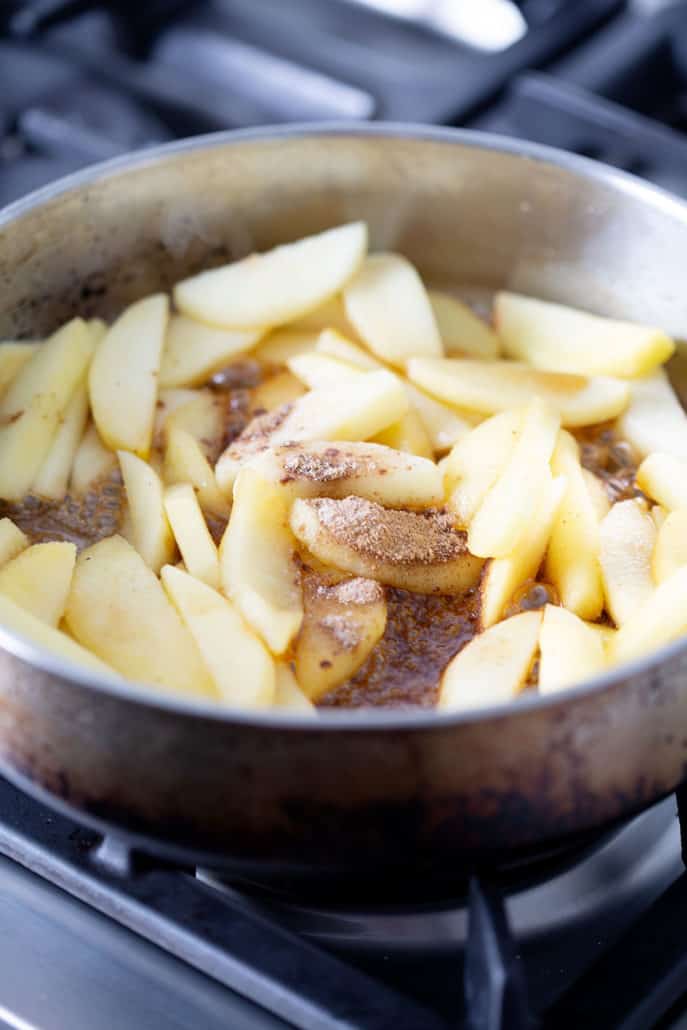 sliced apples with cinnamon in pan on stovetop