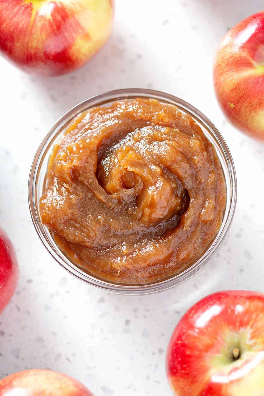 bowl of instant pot apple butter from above surrounded by apples