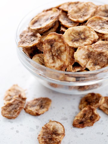 bowl of dehydrated banana chips on white counter