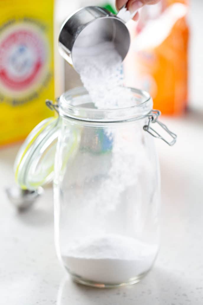 pouring ingredients into glass container