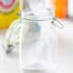 pouring homemade laundry detergent powder into container