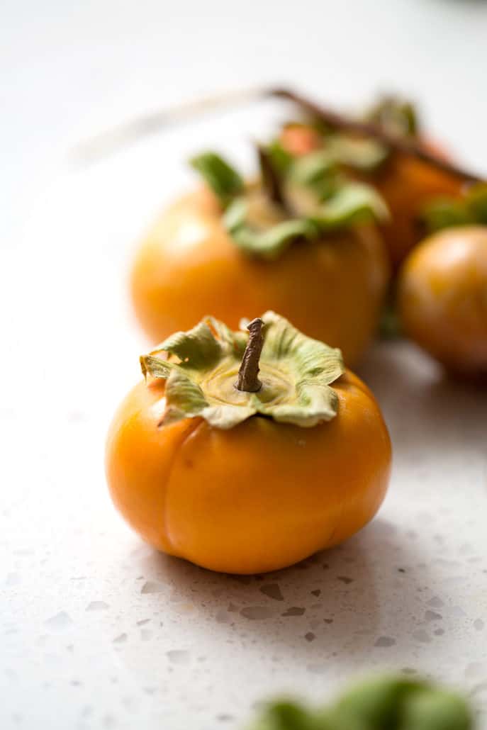 persimmons on white background