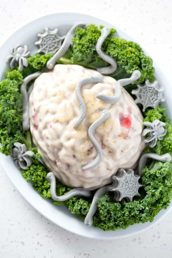brain shaped jello of bed of kale on white background