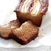 AIP banana bread loaf with slices on parchment and wire rack