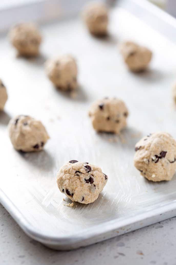 balls of chocolate chip cookie dough on baking sheet