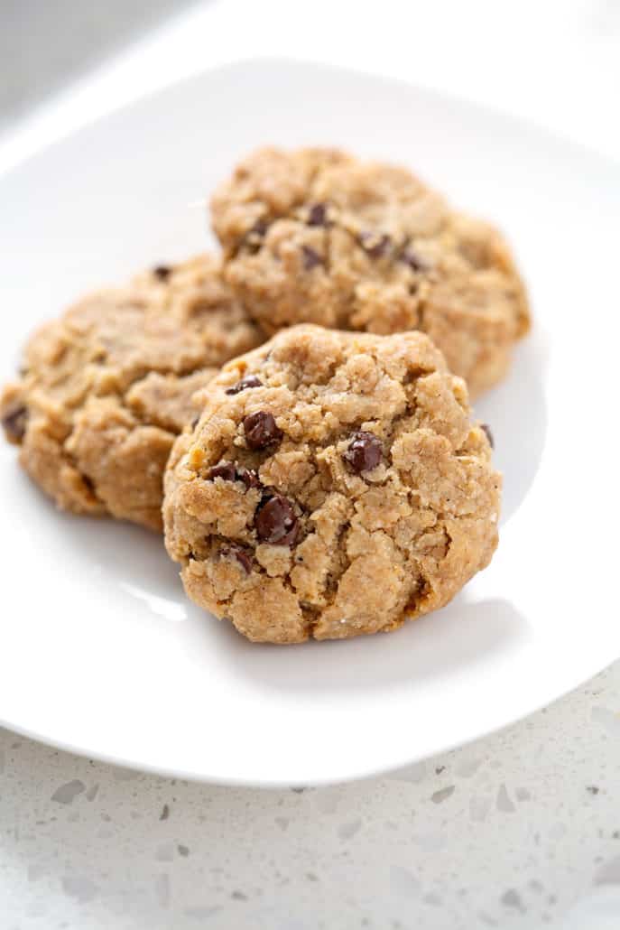 close up of white plate of chocolate chip cookies