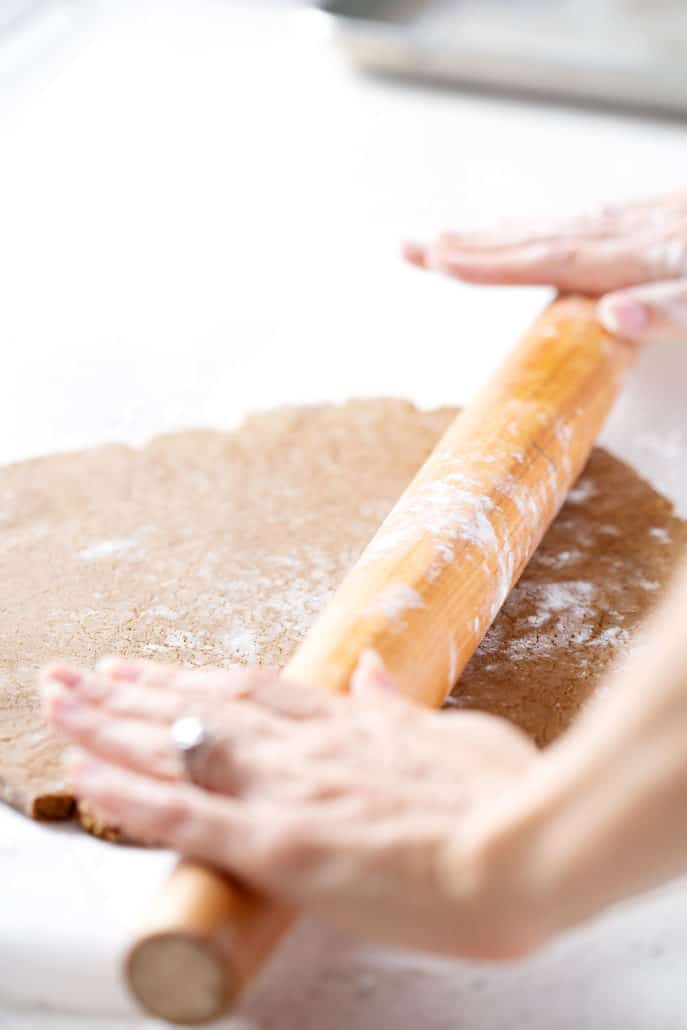rolling out aip gingerbread cookie dough with rolling pin