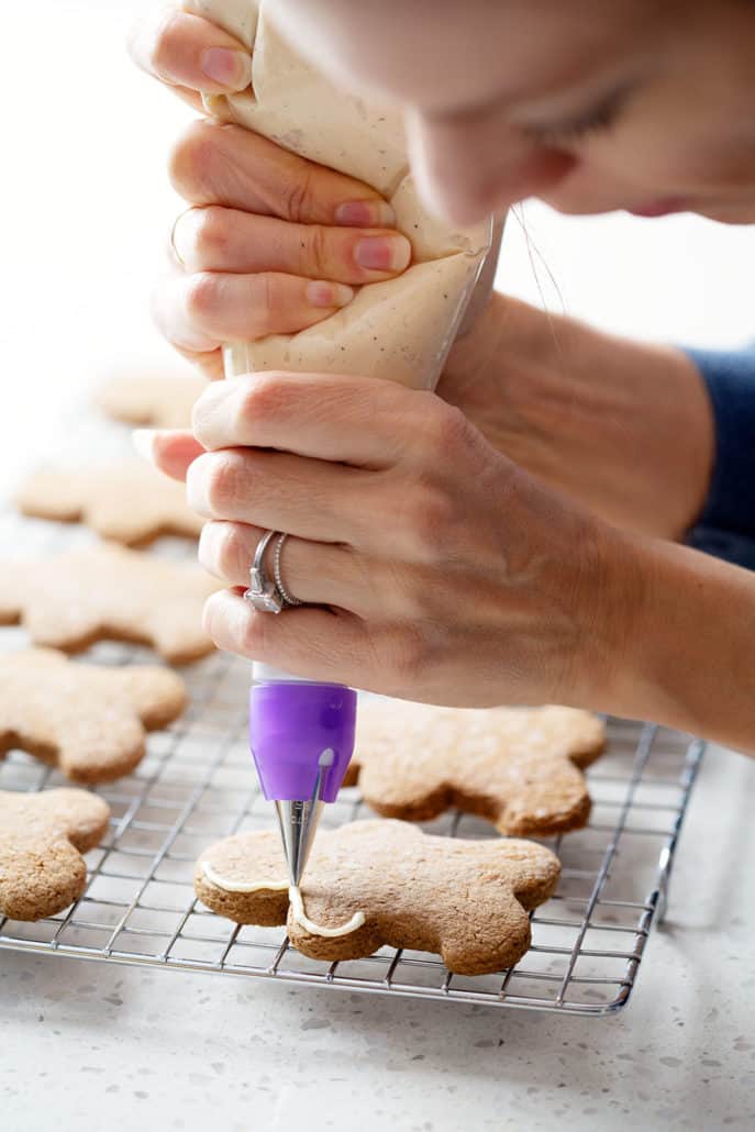 piping icing onto aip gingerbread cookies