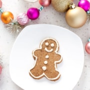 aip gingerbread cookie on white plate with Christmas decorations