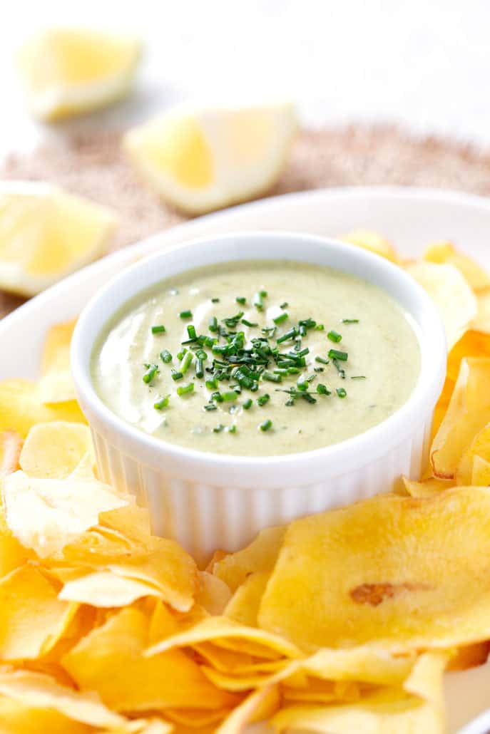 bowl of dip with chives surrounded by chips