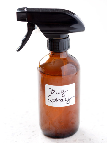 amber spray bottle with the words bug spray